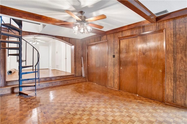 foyer with lofted ceiling with beams, light parquet floors, and wooden walls