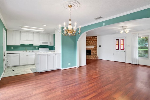 kitchen featuring light hardwood / wood-style flooring, pendant lighting, white appliances, and white cabinets