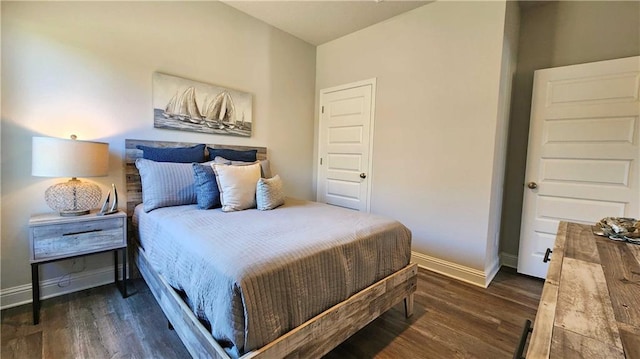 bedroom with dark hardwood / wood-style flooring