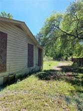 view of side of property with a lawn