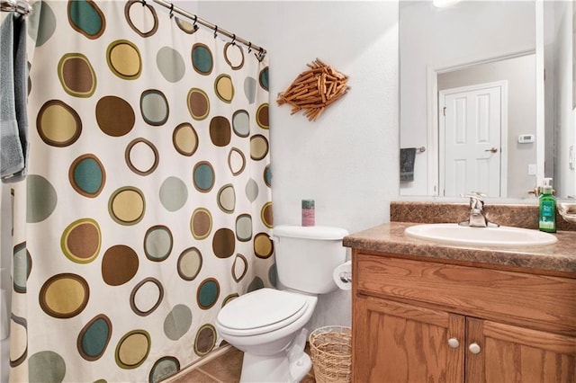 bathroom featuring vanity, tile patterned floors, and toilet