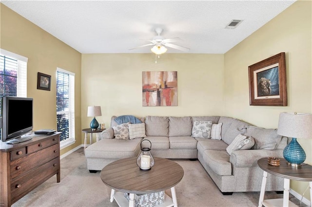 carpeted living room featuring ceiling fan