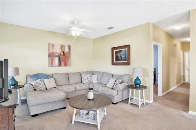 carpeted living room featuring ceiling fan