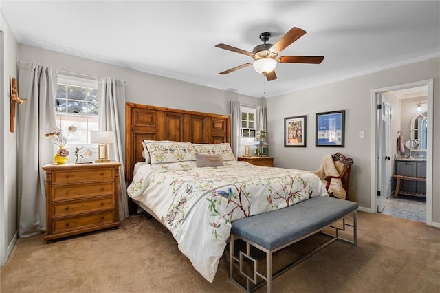 bedroom featuring ceiling fan, carpet floors, ornamental molding, and ensuite bath