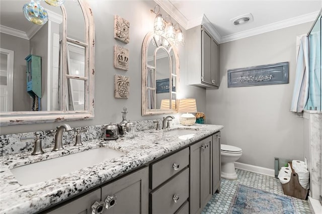 bathroom featuring tile patterned floors, vanity, toilet, and crown molding