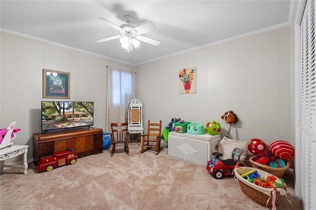 recreation room with light carpet, ceiling fan, and crown molding