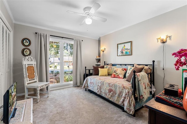 bedroom with carpet, a closet, ceiling fan, and ornamental molding