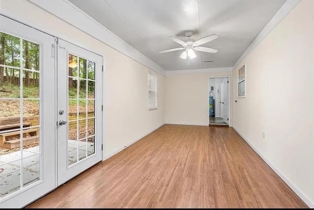 empty room featuring ceiling fan, french doors, and light hardwood / wood-style flooring