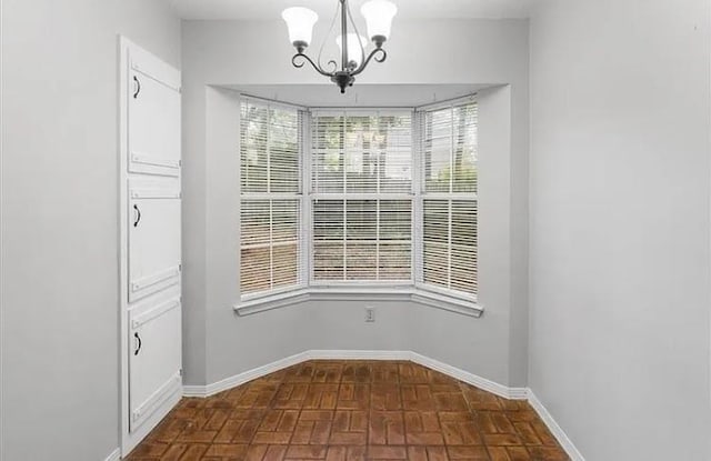 unfurnished dining area featuring a notable chandelier