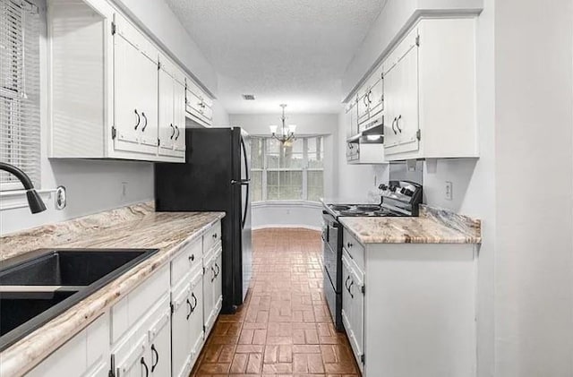 kitchen featuring stainless steel electric stove, sink, white cabinets, and decorative light fixtures