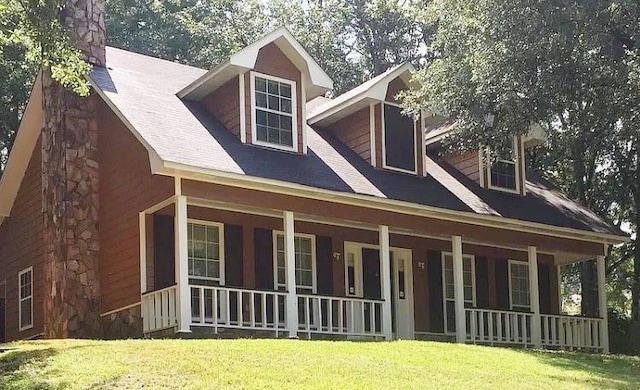 exterior space featuring a lawn and a porch