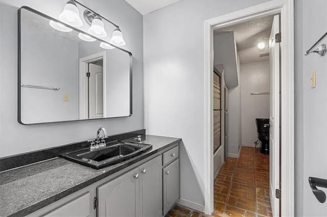 2751 Hamilton Creek Dr W, Mobile, AL 36695 - bathroom featuring baseboards, brick floor, and vanity