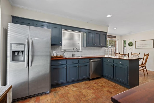3420 Floyd Cir E, Semmes, AL 36575 - kitchen with stainless steel appliances, ornamental molding, a peninsula, tasteful backsplash, and brick patterned flooring