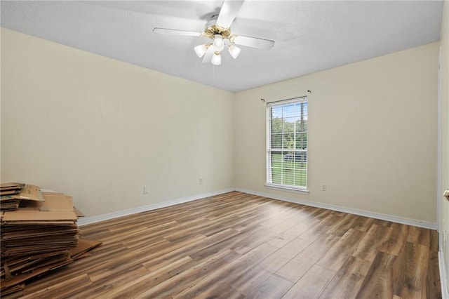 3420 Floyd Cir E, Semmes, AL 36575 - empty room with wood finished floors, ceiling fan, and a textured ceiling