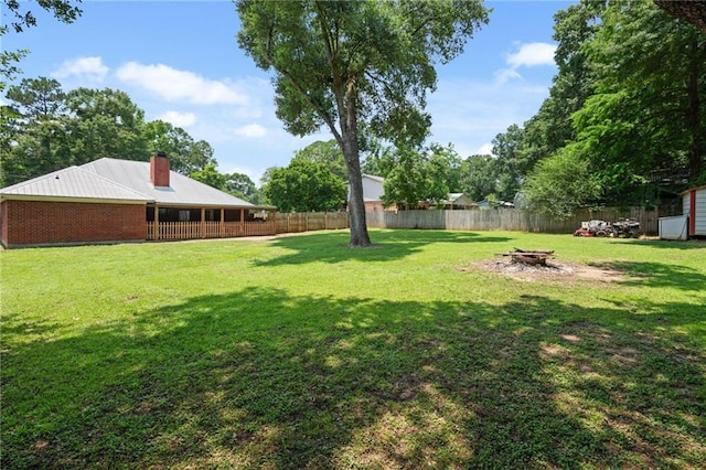 3420 Floyd Cir E, Semmes, AL 36575 - fenced backyard featuring an outdoor fire pit