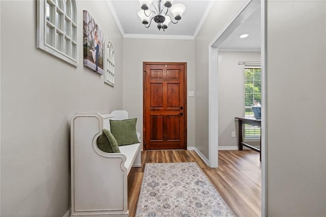 3420 Floyd Cir E, Semmes, AL 36575 - foyer entrance featuring wood finished floors, a chandelier, and crown molding