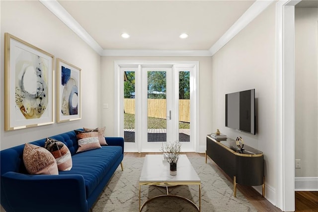 living room featuring wood-type flooring and crown molding