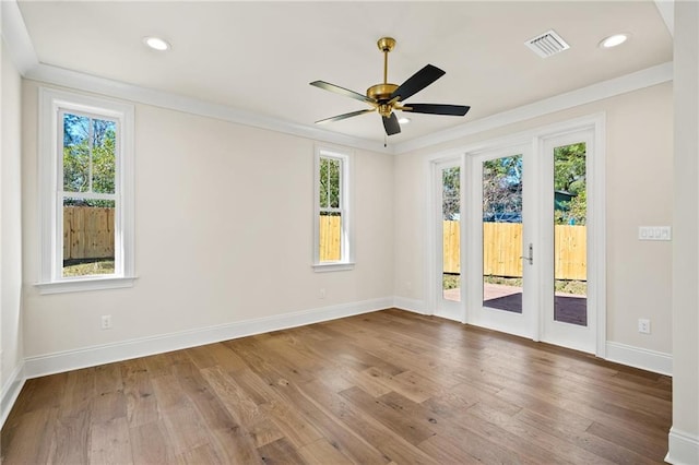 unfurnished room with ceiling fan, hardwood / wood-style flooring, and crown molding