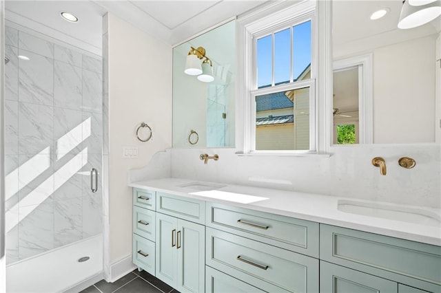 bathroom featuring a marble finish shower, double vanity, a sink, and recessed lighting