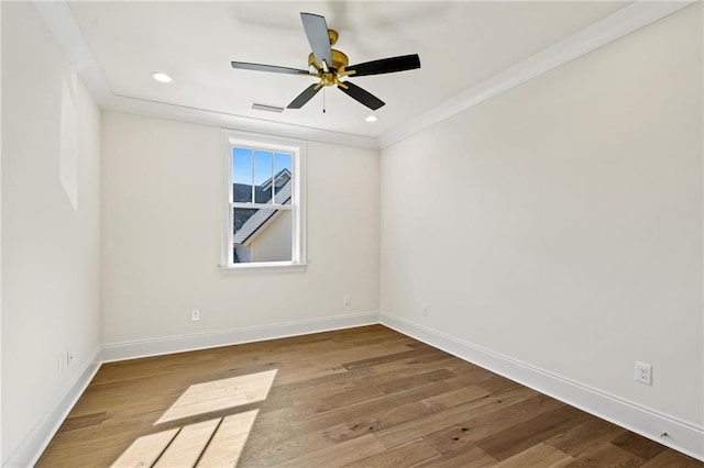 unfurnished room featuring a ceiling fan, visible vents, baseboards, and wood finished floors