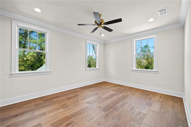 empty room with light hardwood / wood-style floors, ceiling fan, and crown molding