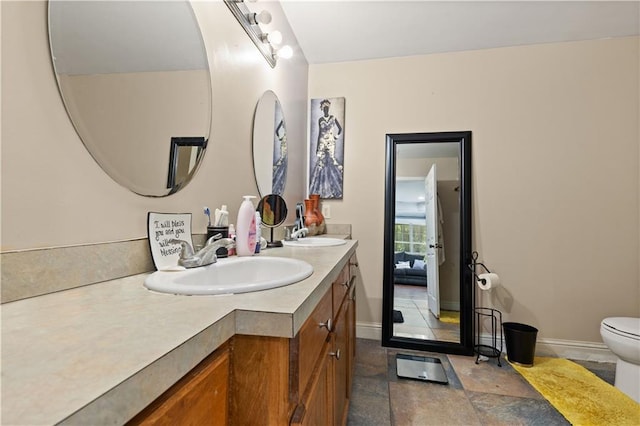 bathroom featuring double vanity, tile patterned flooring, and toilet