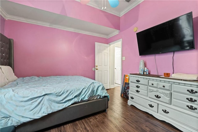 bedroom with dark hardwood / wood-style floors, ornamental molding, and ceiling fan