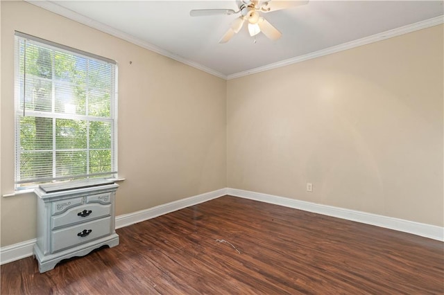 spare room with ornamental molding, a wealth of natural light, ceiling fan, and dark hardwood / wood-style floors