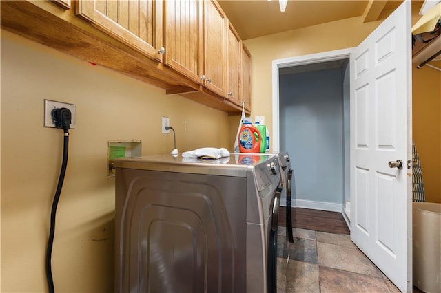 washroom with washing machine and clothes dryer, tile patterned floors, and cabinets