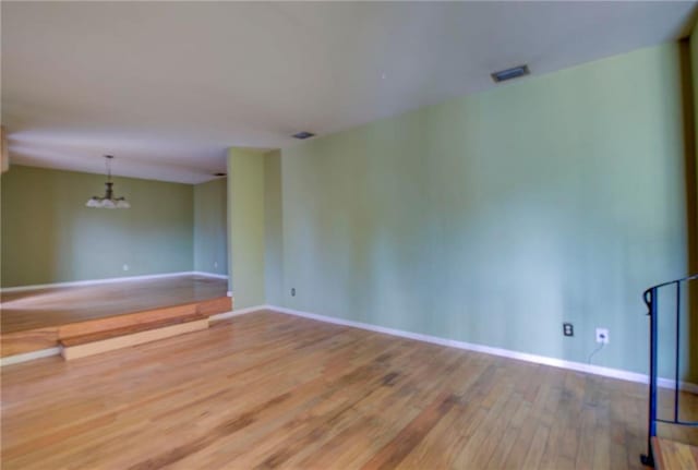 empty room with hardwood / wood-style floors