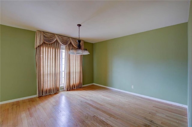 spare room featuring light hardwood / wood-style flooring