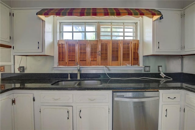 kitchen with dishwasher, white cabinetry, dark stone countertops, and sink