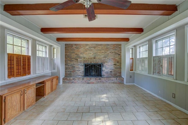 unfurnished living room with beam ceiling, a brick fireplace, ceiling fan, and light tile patterned flooring