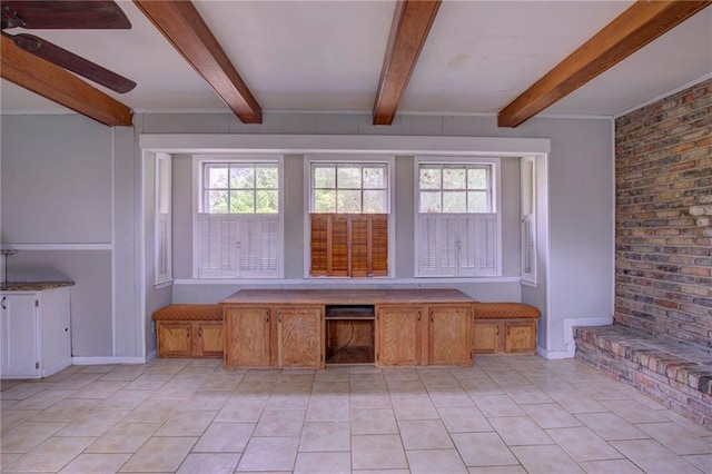 interior space featuring ceiling fan and beamed ceiling