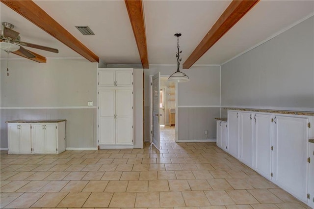 interior space featuring beam ceiling and ceiling fan