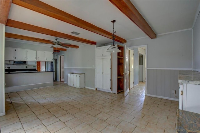 unfurnished living room with beamed ceiling, light tile patterned floors, ceiling fan, and ornamental molding