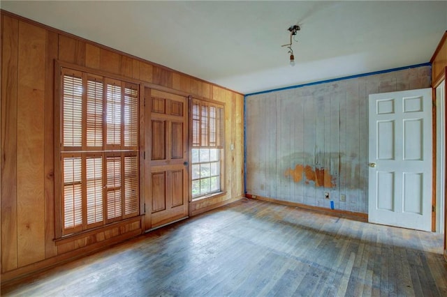 entryway featuring hardwood / wood-style floors and wooden walls