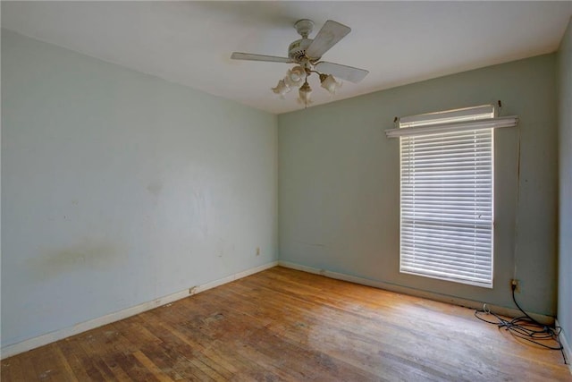 empty room with ceiling fan and light hardwood / wood-style floors