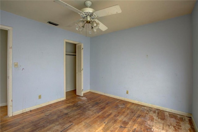 unfurnished bedroom featuring a closet, ceiling fan, and hardwood / wood-style floors