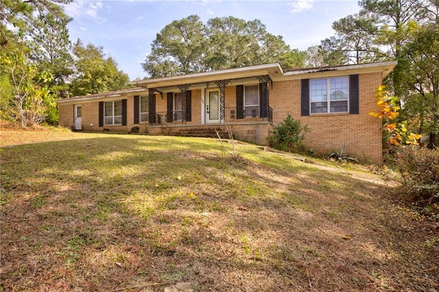 ranch-style house with a front lawn and covered porch