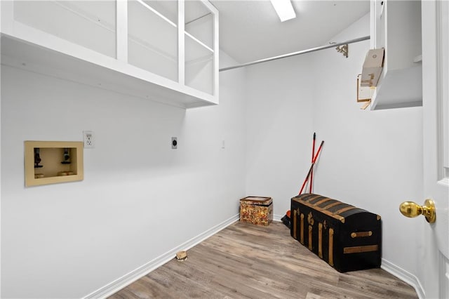 laundry room featuring electric dryer hookup, hookup for a washing machine, and hardwood / wood-style flooring