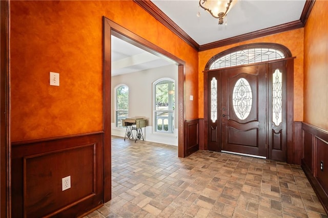 foyer entrance featuring ornamental molding