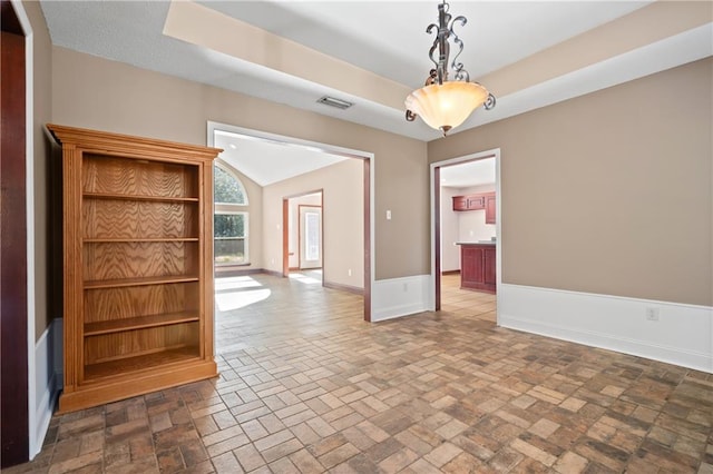 empty room featuring lofted ceiling