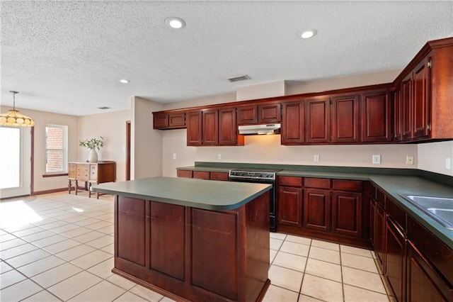 kitchen with light tile patterned floors, a center island, a textured ceiling, and stainless steel electric range oven