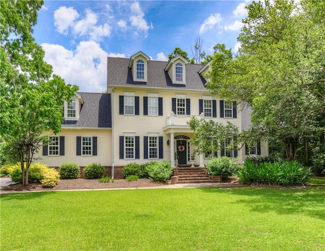 colonial-style house with a front yard