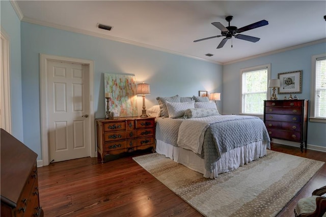 bedroom featuring ceiling fan, dark hardwood / wood-style flooring, and crown molding