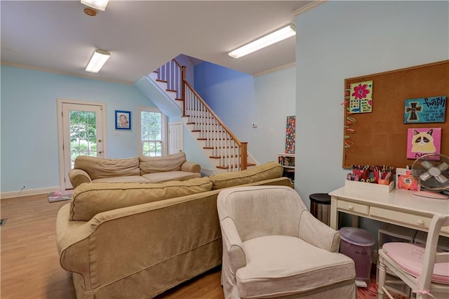 living room featuring hardwood / wood-style flooring and ornamental molding