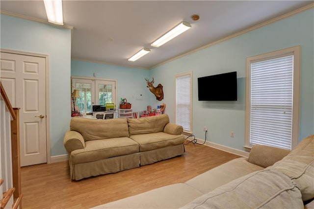 living room with hardwood / wood-style floors, french doors, and crown molding