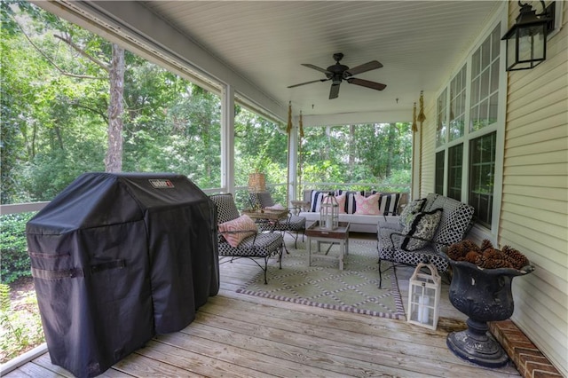 wooden terrace with ceiling fan and a grill