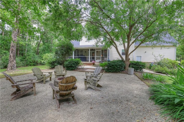 view of terrace with an outdoor fire pit